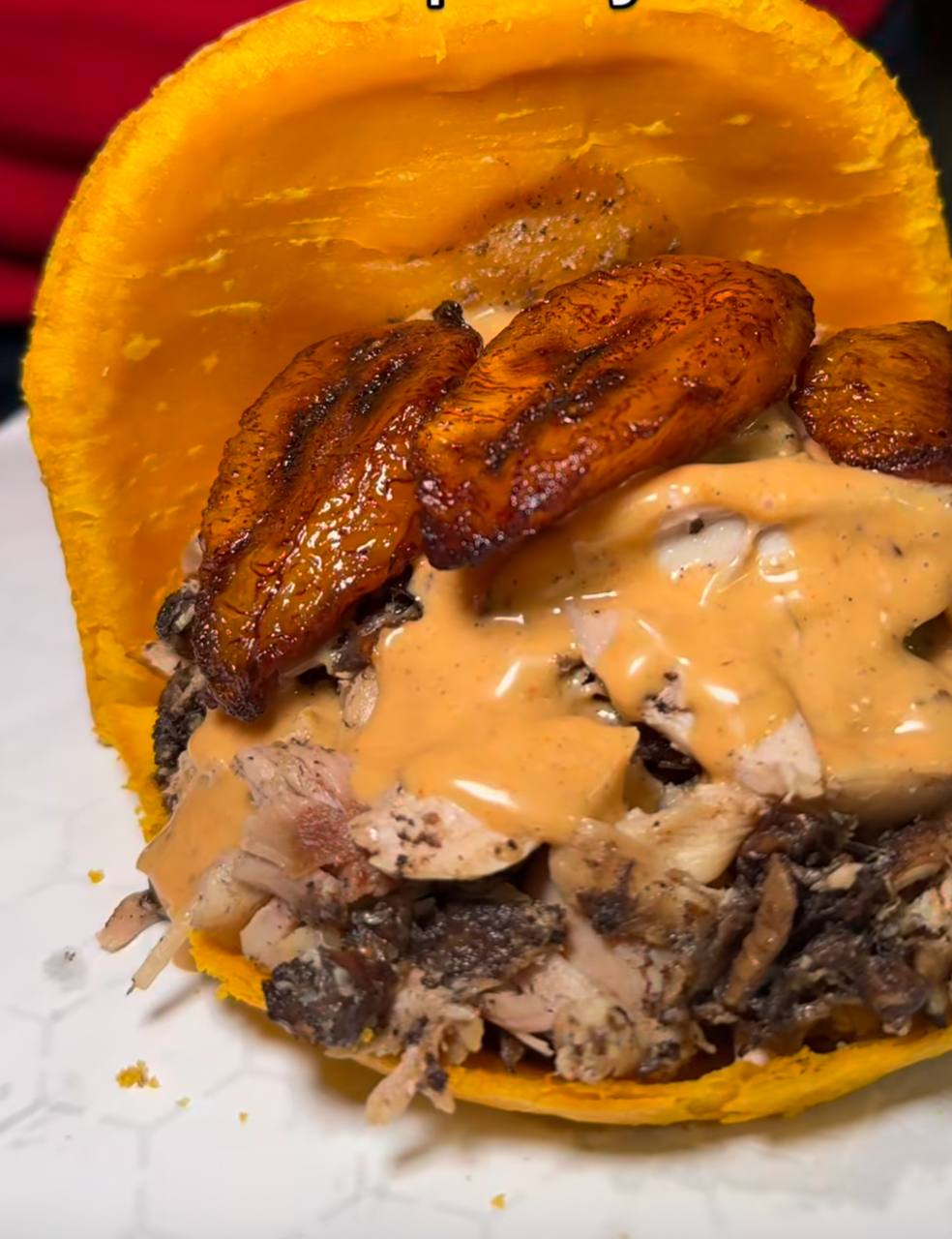 Fried-plantain cup loaded with jerk pork, plantain and house sauce